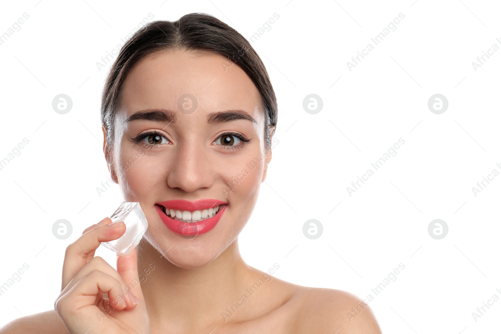 Photo of Young woman with ice cube on white background. Skin care