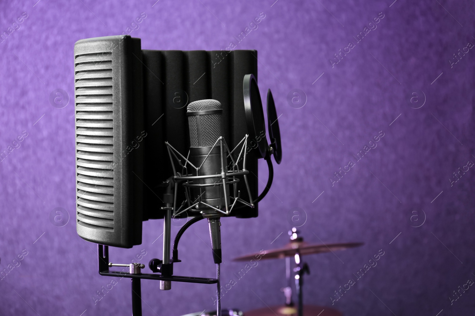 Photo of Condenser microphone in modern recording studio. Space for text