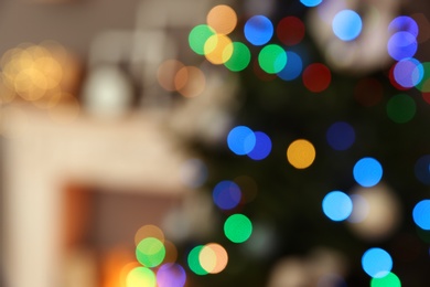 Photo of Blurred view of room interior with decorated Christmas tree