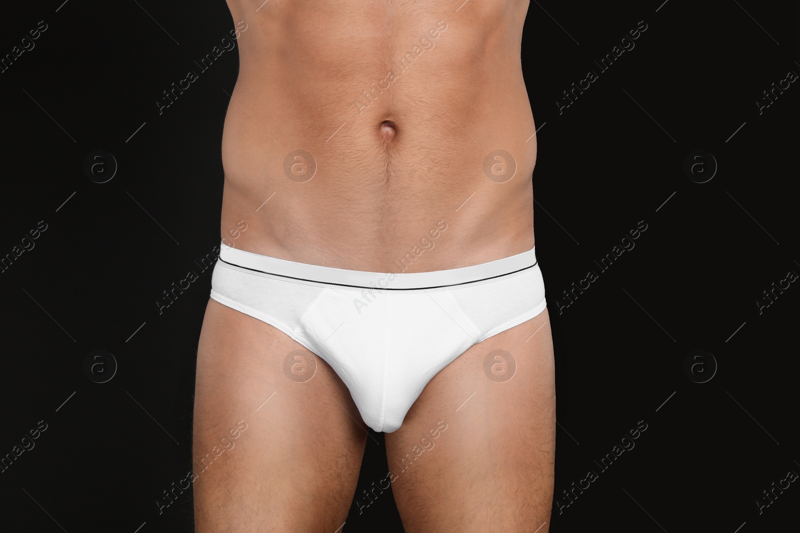 Photo of Man in underwear on black background, closeup