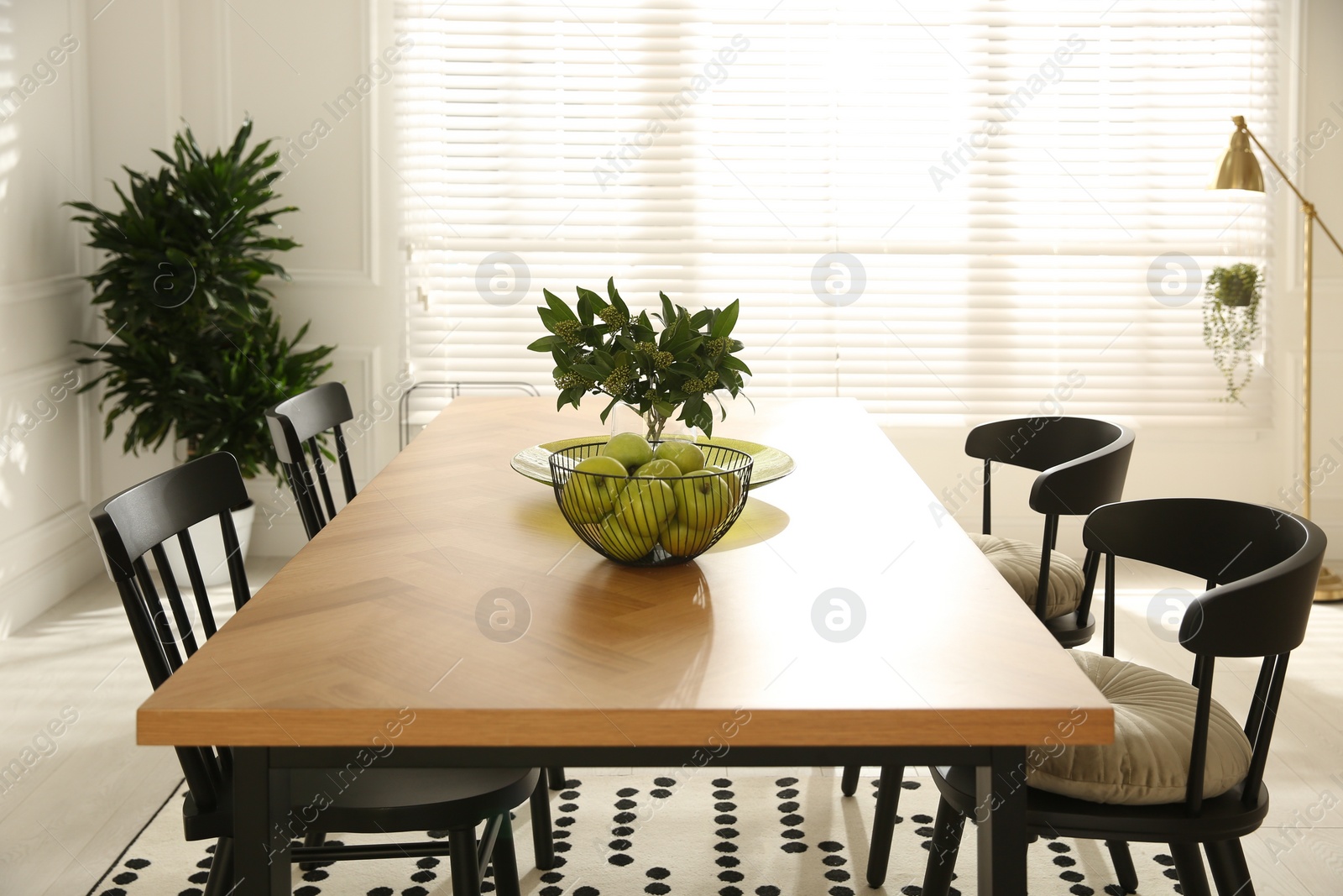 Photo of Stylish wooden dining table and chairs in room. Interior design