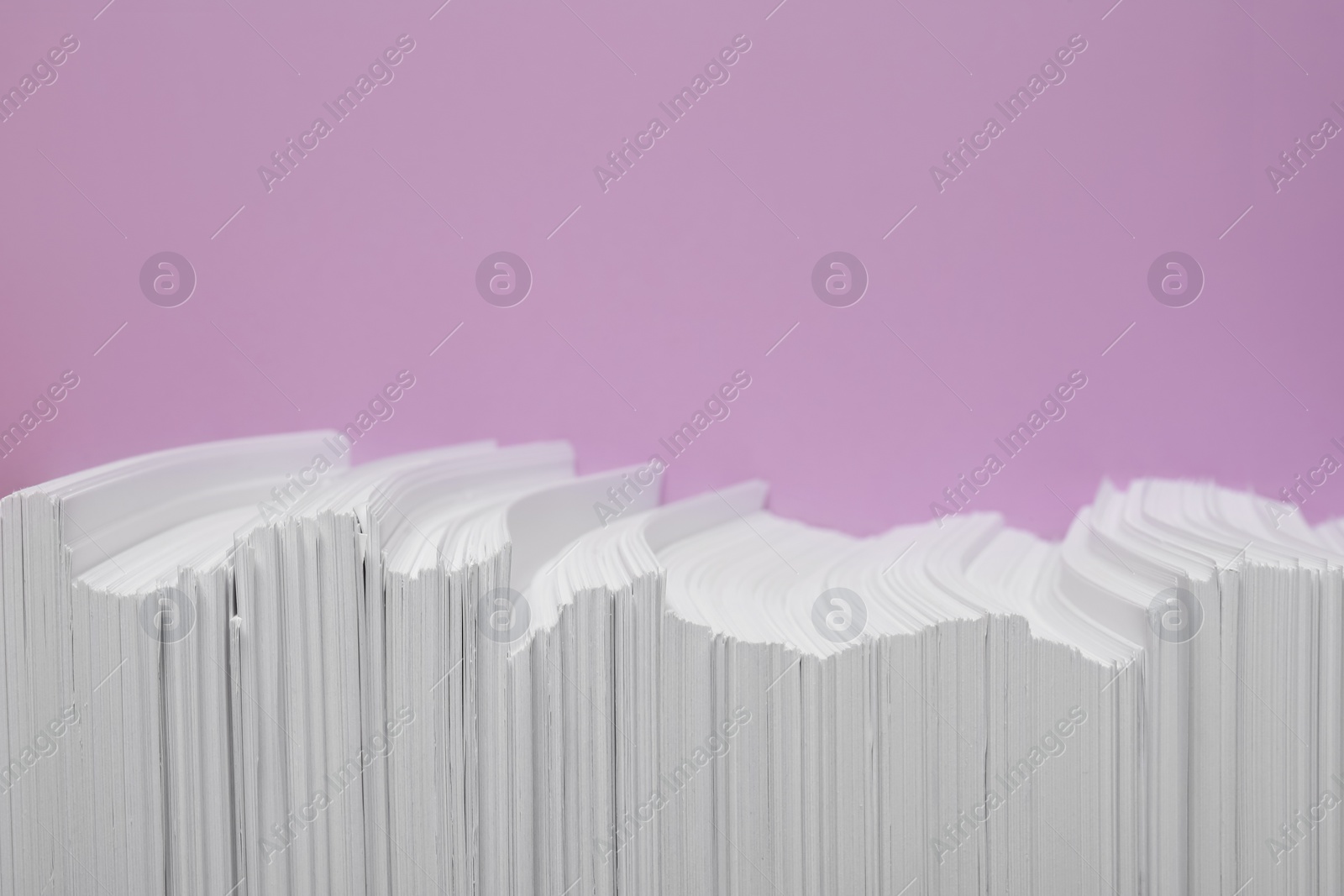 Photo of White paper sheets on violet background, flat lay. Space for text