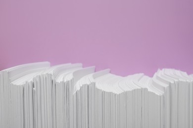 Photo of White paper sheets on violet background, flat lay. Space for text