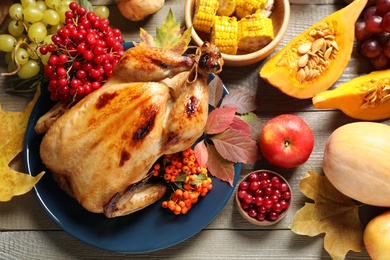 Flat lay composition with delicious turkey on wooden background. Happy Thanksgiving day