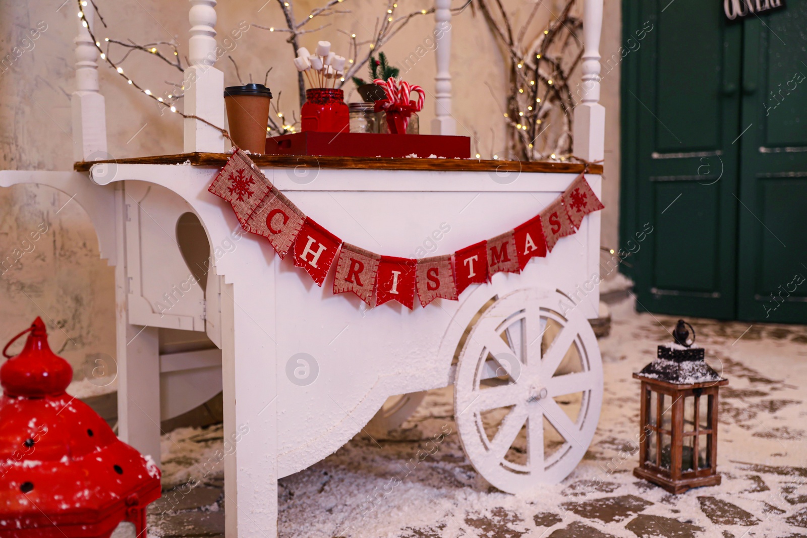 Photo of Candy cart with flag garland on street. Christmas celebration