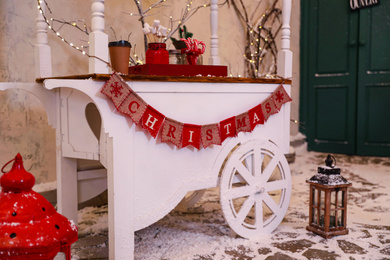 Candy cart with flag garland on street. Christmas celebration