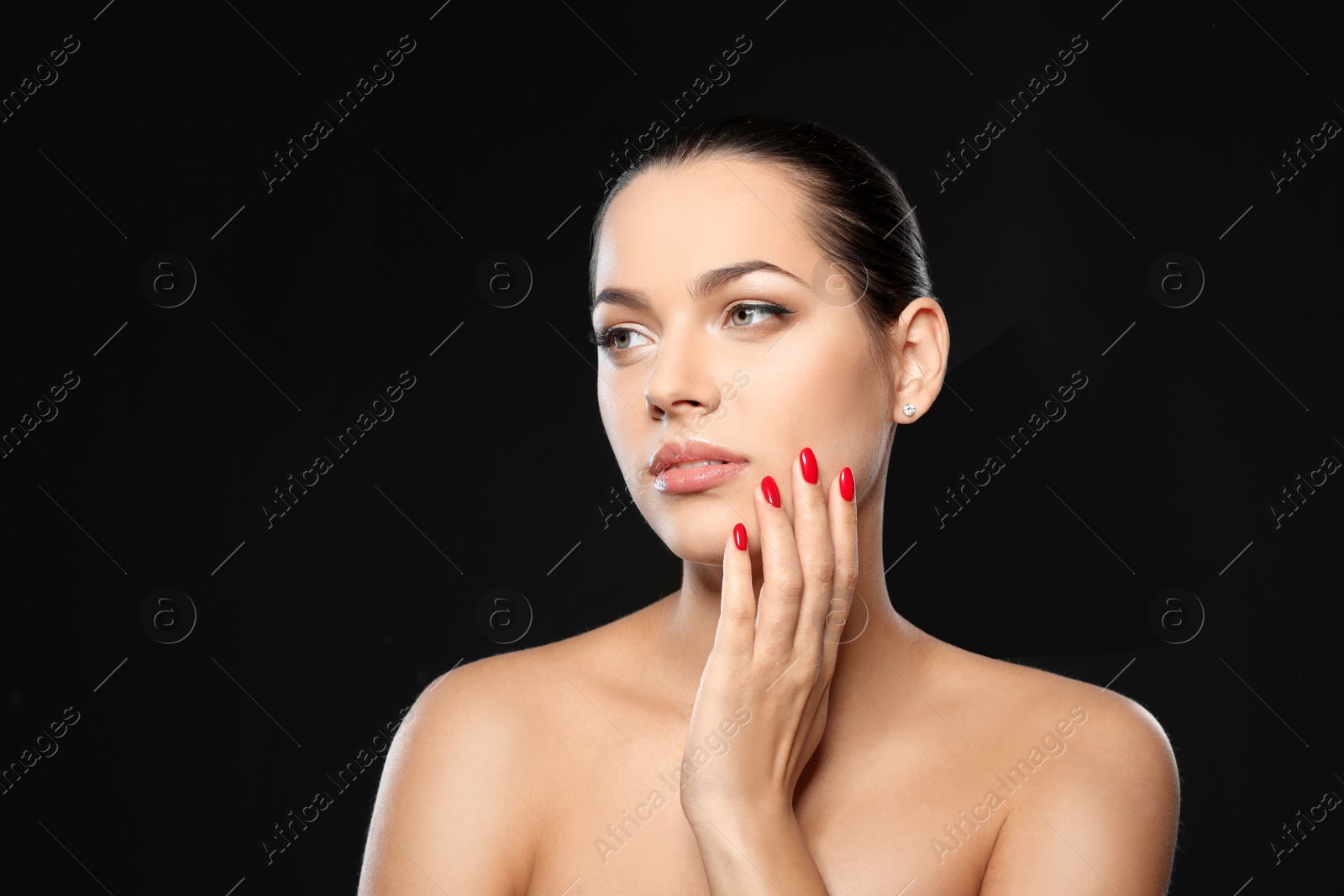 Photo of Portrait of beautiful young woman with bright manicure on black background. Nail polish trends