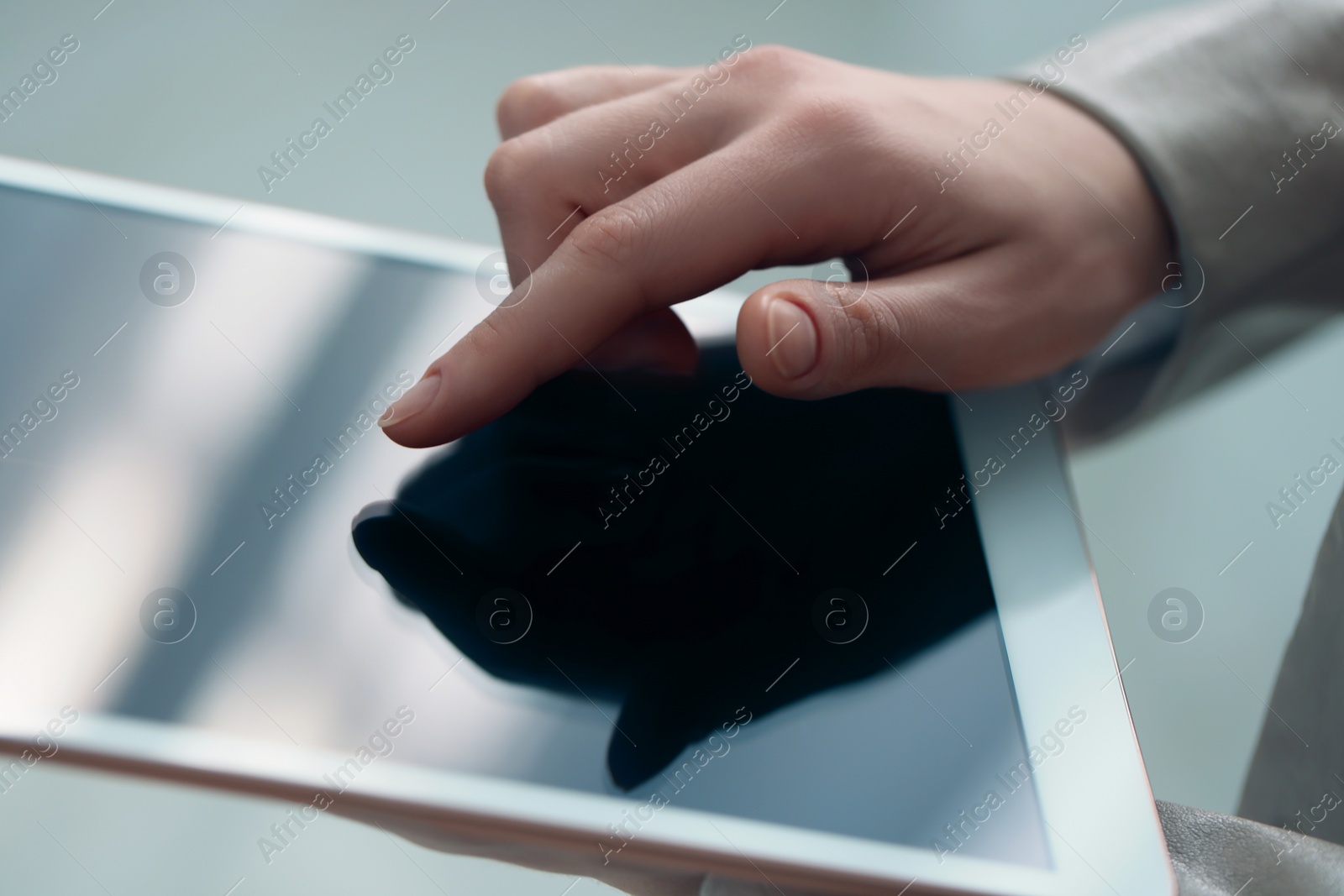 Photo of Closeup view of woman using modern tablet on blurred background