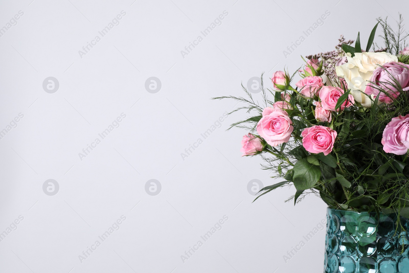 Photo of Beautiful bouquet with roses on white background, closeup. Space for text