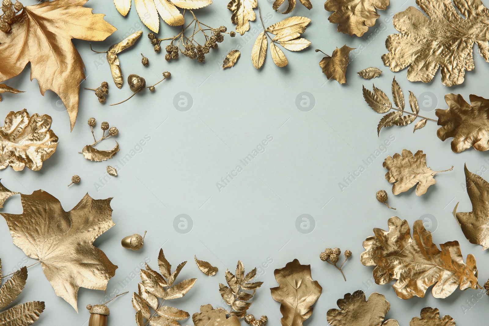 Photo of Frame made of different golden leaves on light grey background, flat lay with space for text. Autumn decor