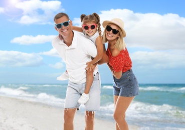 Image of Happy family near sea on sunny day. Summer vacation