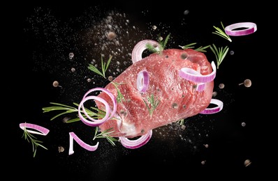 Image of Fresh raw meat and different spices flying on black background