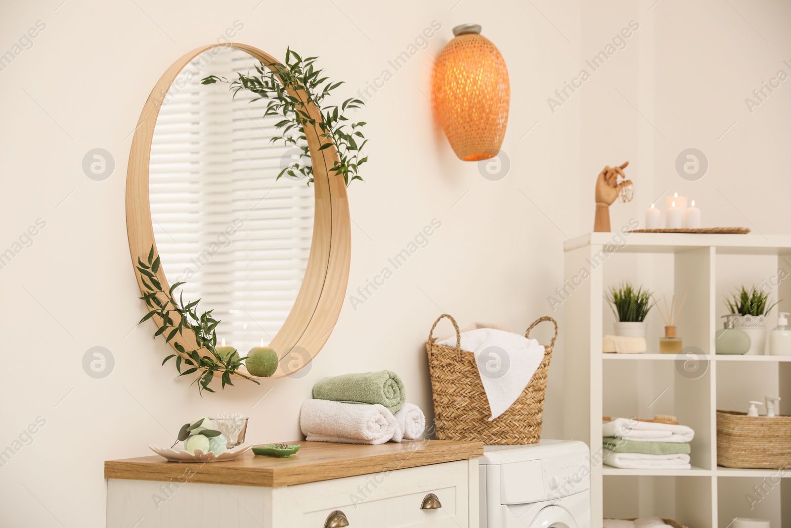 Photo of Round mirror on white wall in modern bathroom