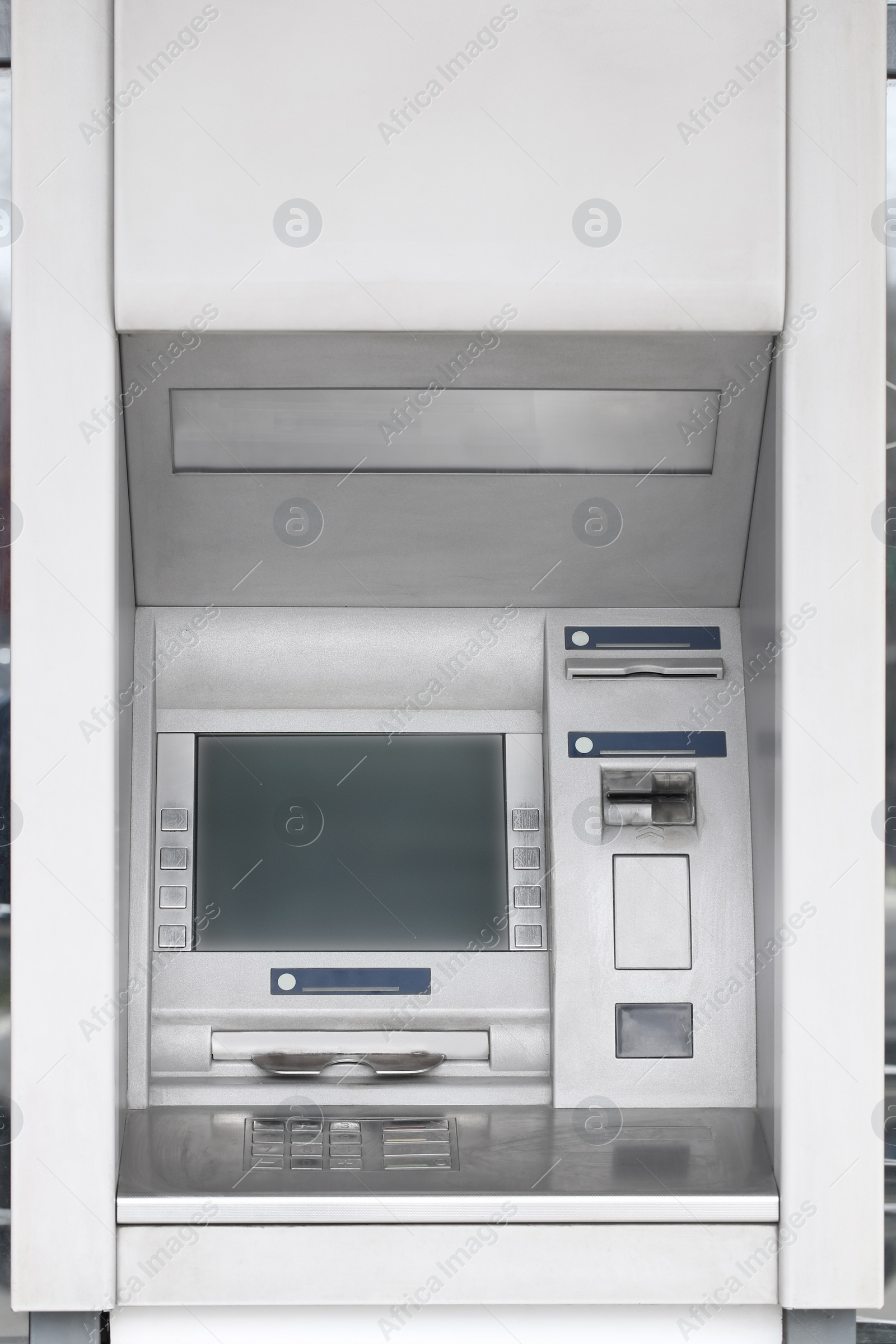 Photo of Modern automated cash machine with screen outdoors