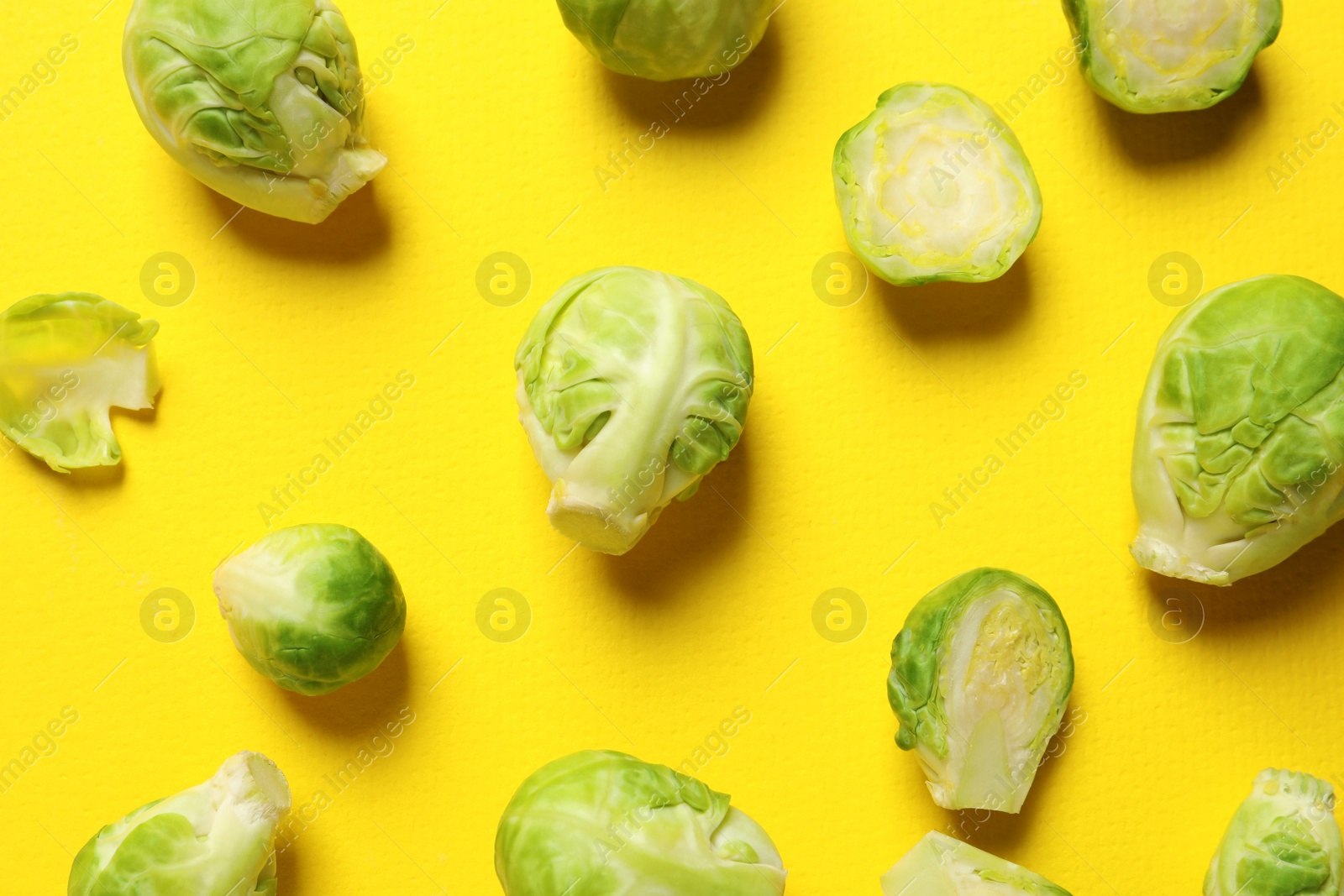 Photo of Fresh Brussels sprouts on color background, flat lay