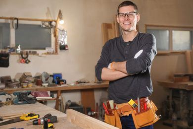 Professional carpenter with set of tools in workshop