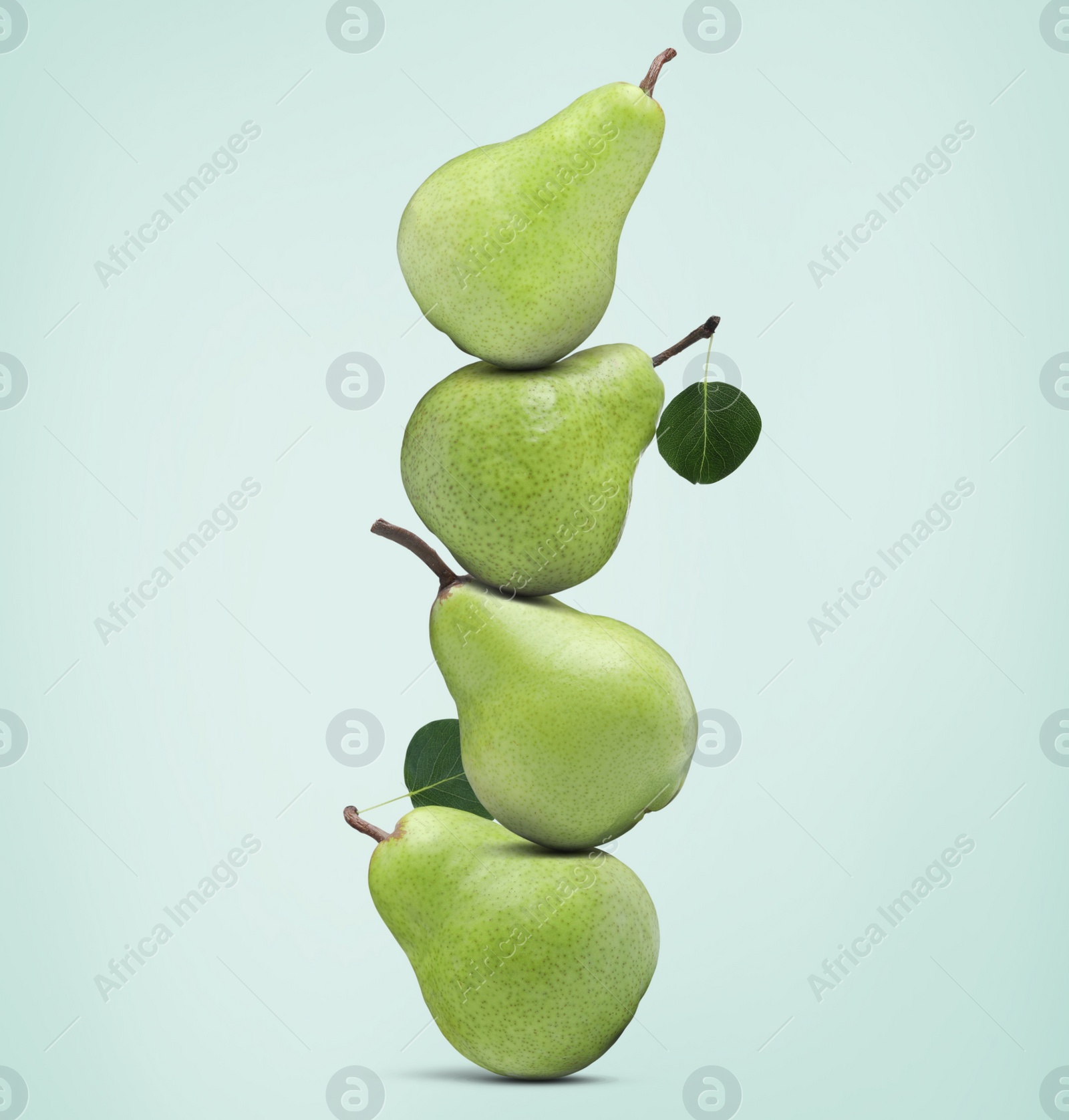 Image of Tasty fresh ripe pears on pale light blue background