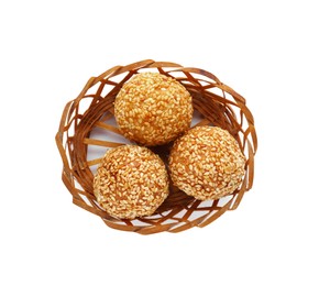 Photo of Wicker basket of delicious sesame balls on white background, top view
