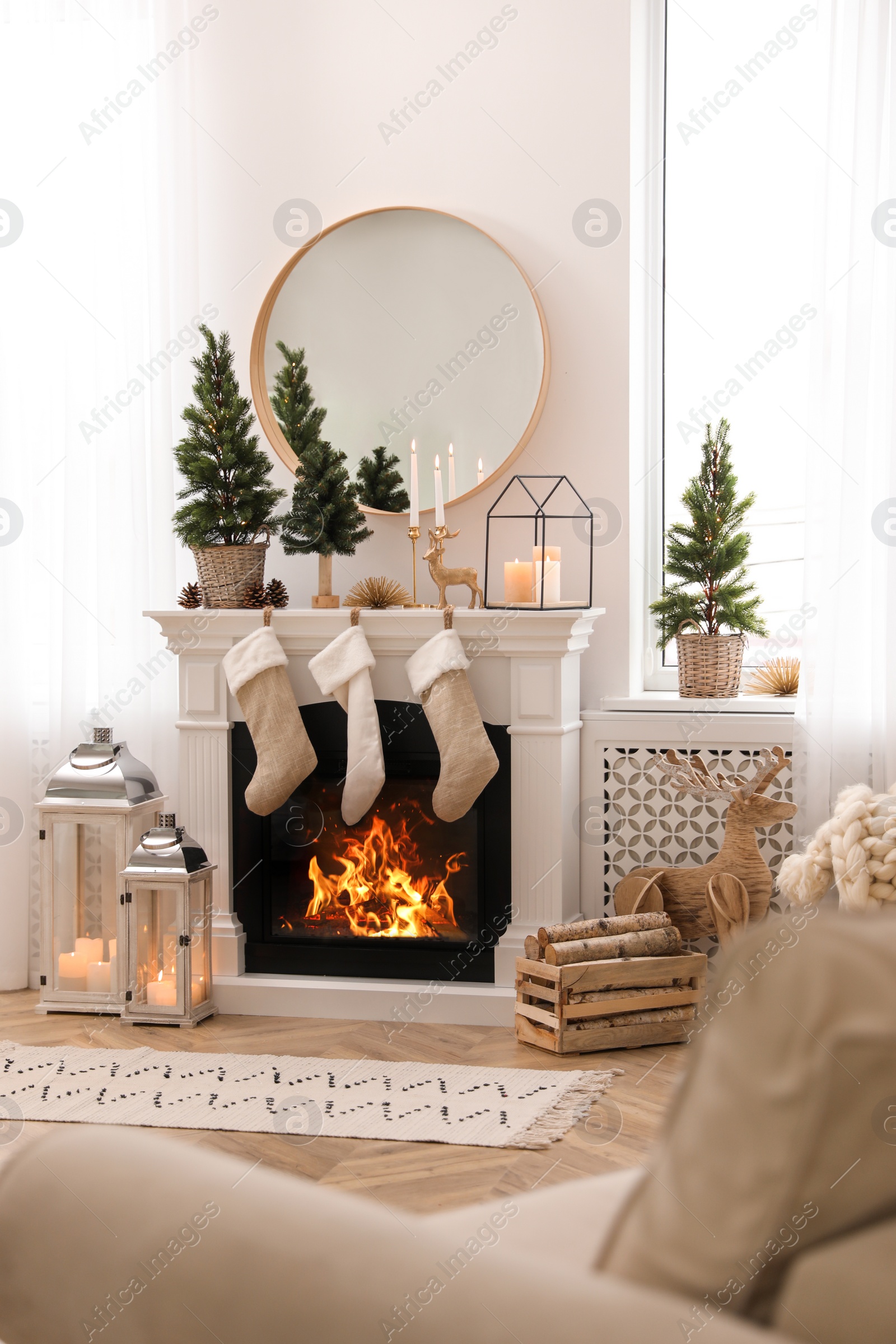 Photo of Fireplace in room with Christmas decorations. Interior design