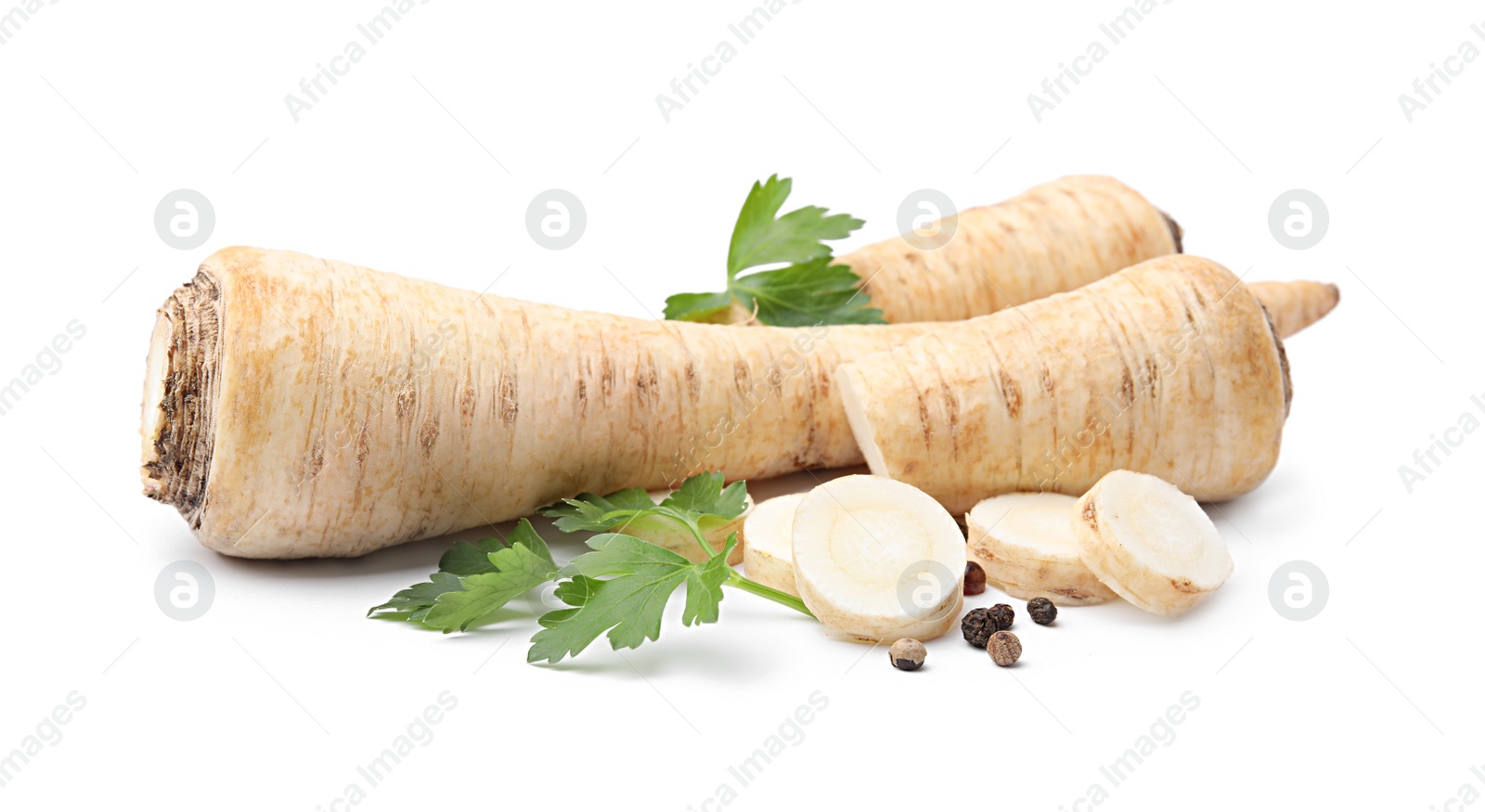 Photo of Whole and cut raw parsley roots, fresh herb isolated on white