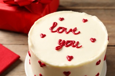 Photo of Bento cake with text Love You on wooden table, closeup. St. Valentine's day surprise