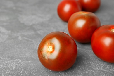 Fresh ripe brown tomatoes on grey table, closeup