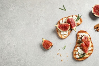 Photo of Bruschettas with ripe figs and cheese on light table, flat lay. Space for text