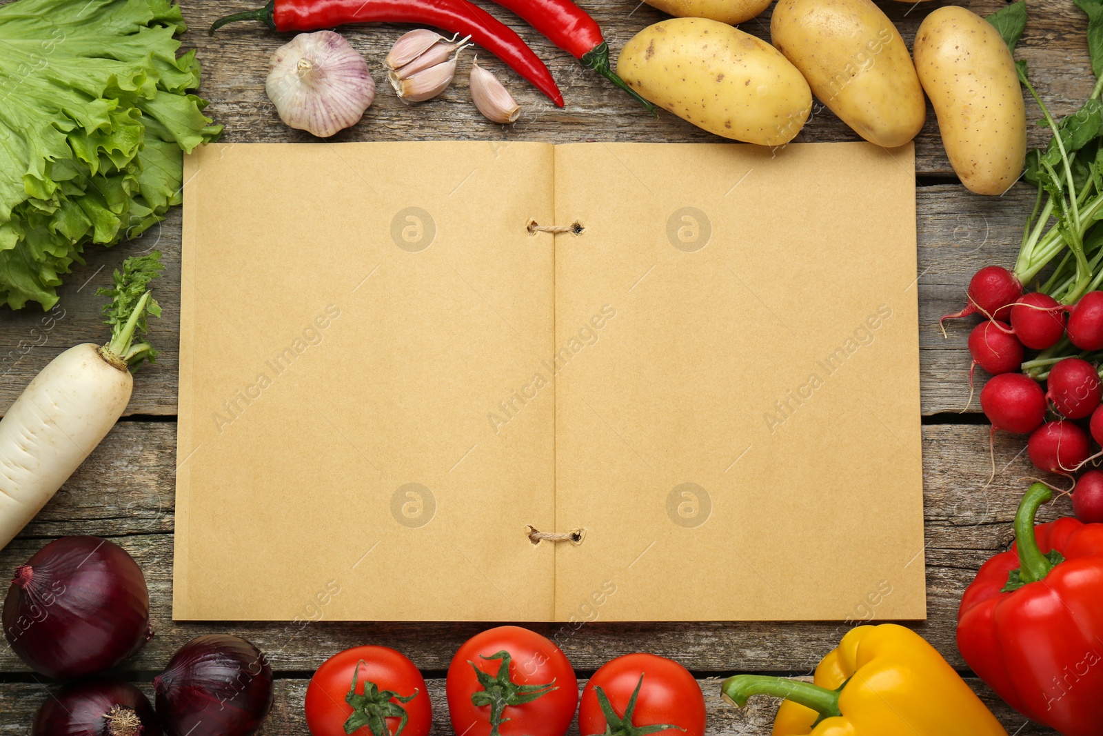 Photo of Blank recipe book and different ingredients on wooden table, flat lay. Space for text