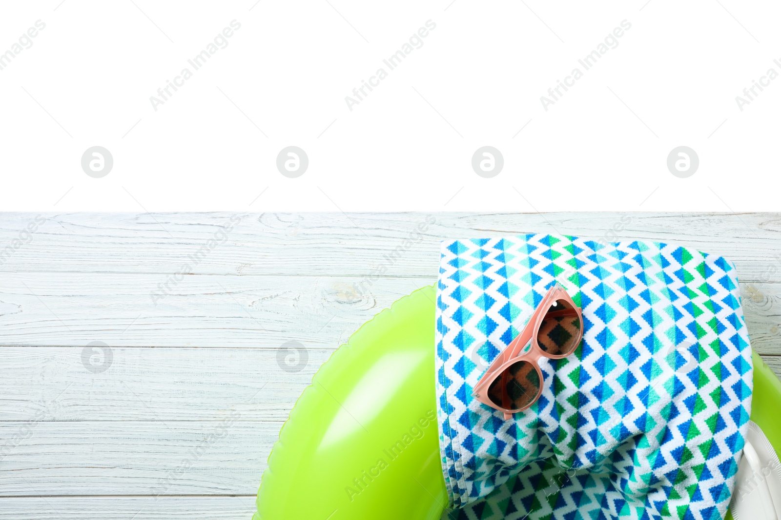 Photo of Flat lay composition with beach accessories on wooden background. Space for text