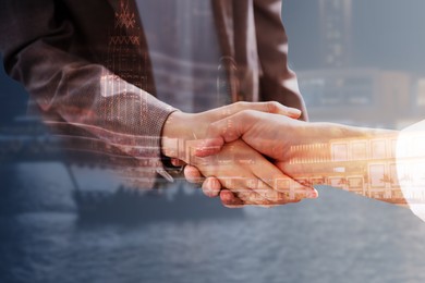 Double exposure of partners shaking hands and cityscape