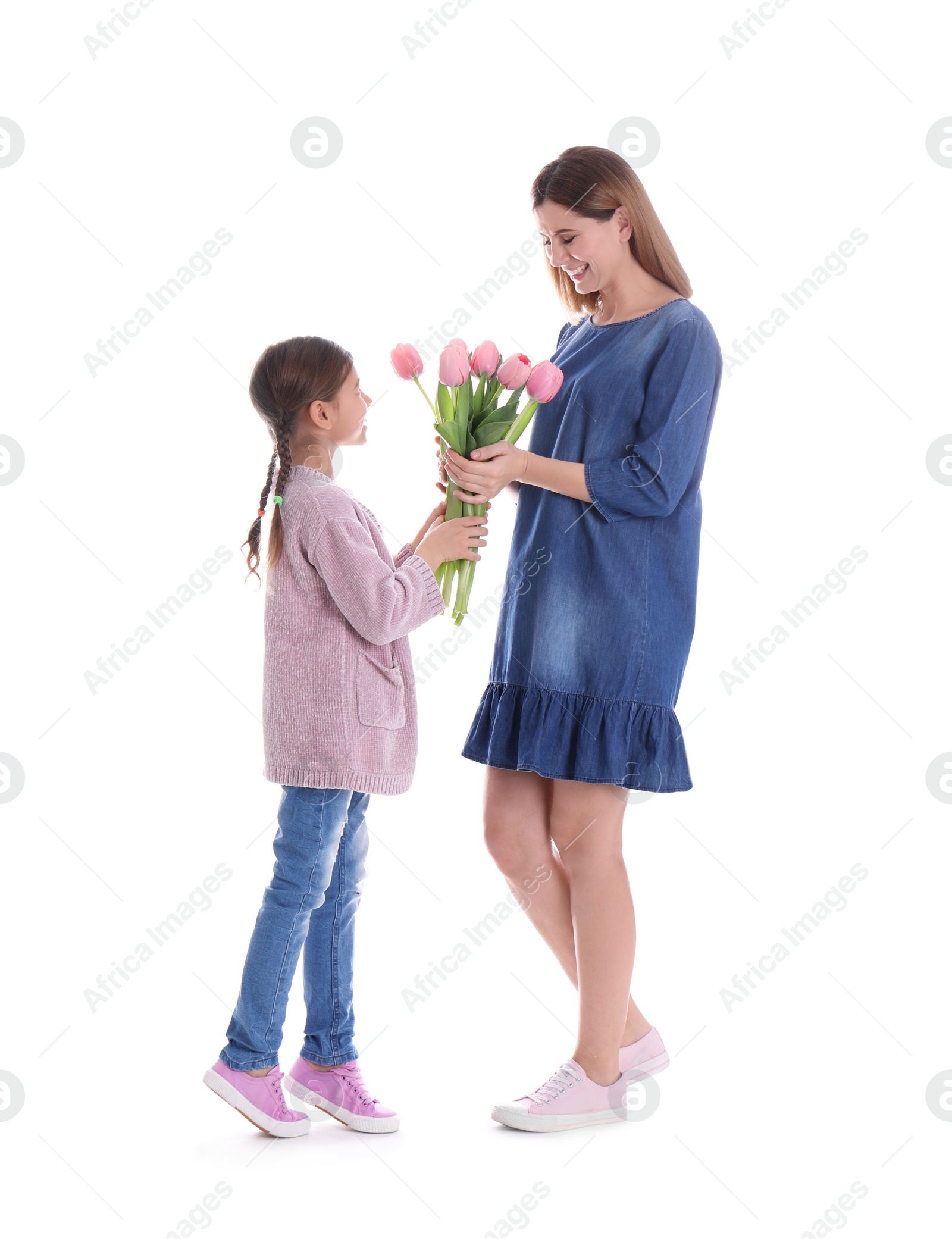 Photo of Happy mother and daughter with flowers on white background. International Women's Day