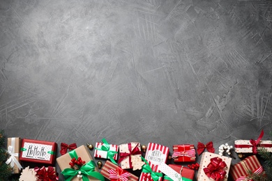 Photo of Flat lay composition with Christmas gift boxes on grey background. Space for text