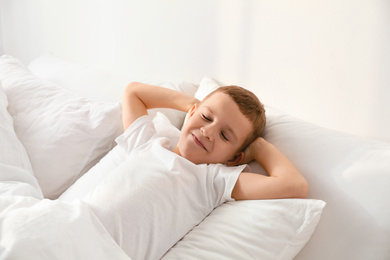 Photo of Cute little boy sleeping in bed at home