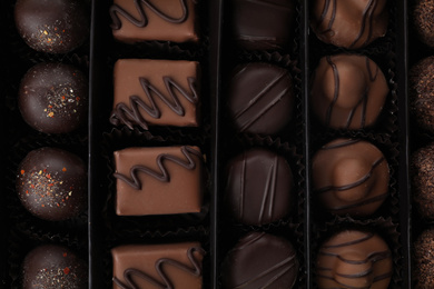 Photo of Many different chocolate candies in box, closeup