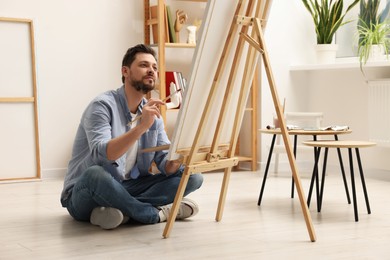 Handsome man painting in studio. Creative hobby