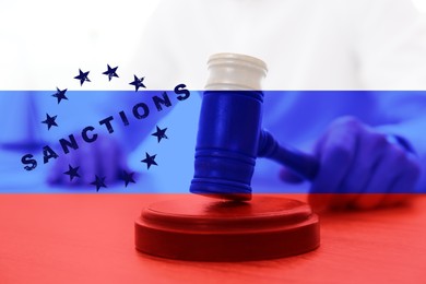 Image of Double exposure of judge with gavel and Russian flag. Concept of sanctions against Russia