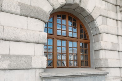 Photo of View of beautiful arched window in building outdoors