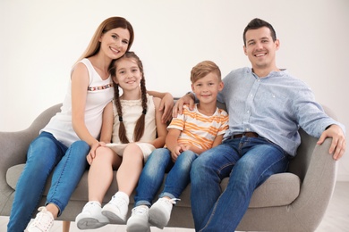 Photo of Happy family with cute children on sofa at home