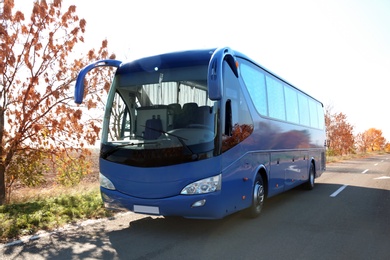 Photo of Modern blue bus on road. Passenger transportation