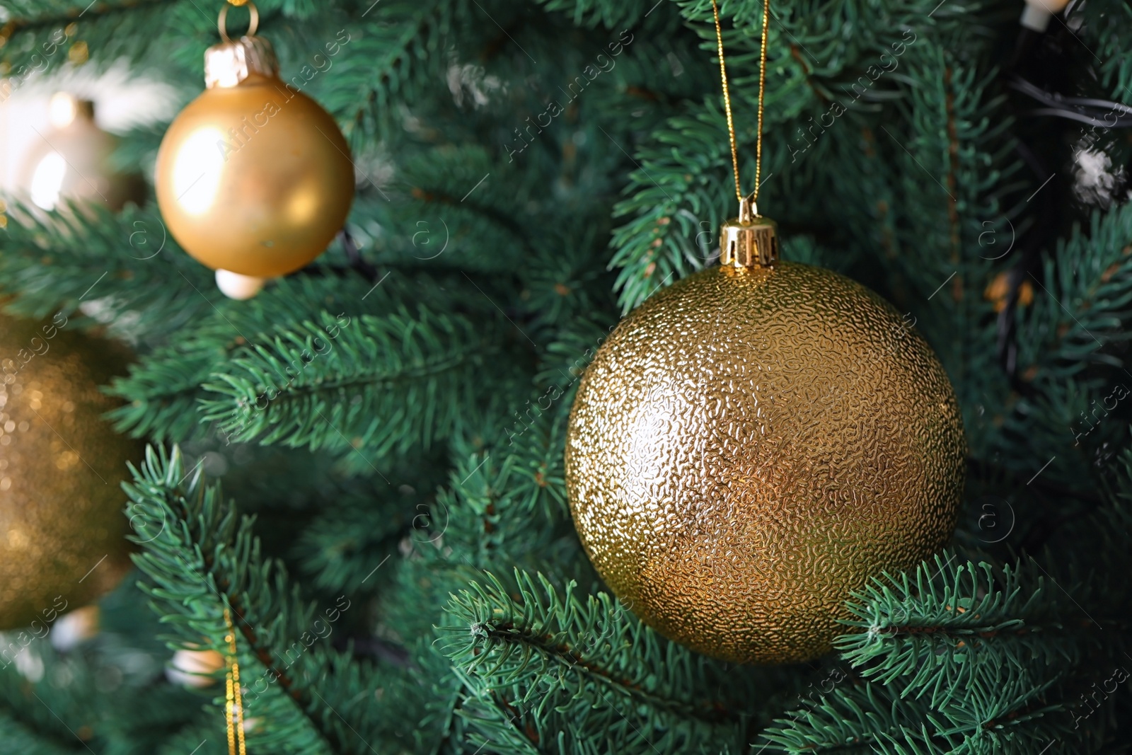 Photo of Beautiful Christmas tree with festive decor on light background, closeup