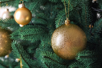 Beautiful Christmas tree with festive decor on light background, closeup