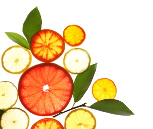 Photo of Illuminated slices of citrus fruits and leaves on white background, top view