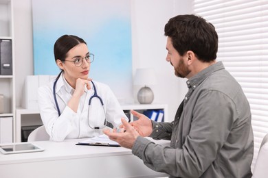 Photo of Doctor consulting patient during appointment in clinic