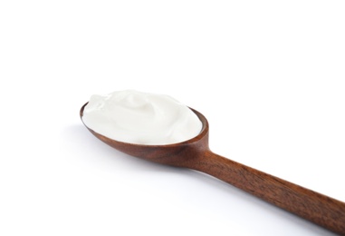 Wooden spoon with sour cream on white background