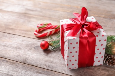 Beautiful composition with gift box and Christmas decorations on wooden table