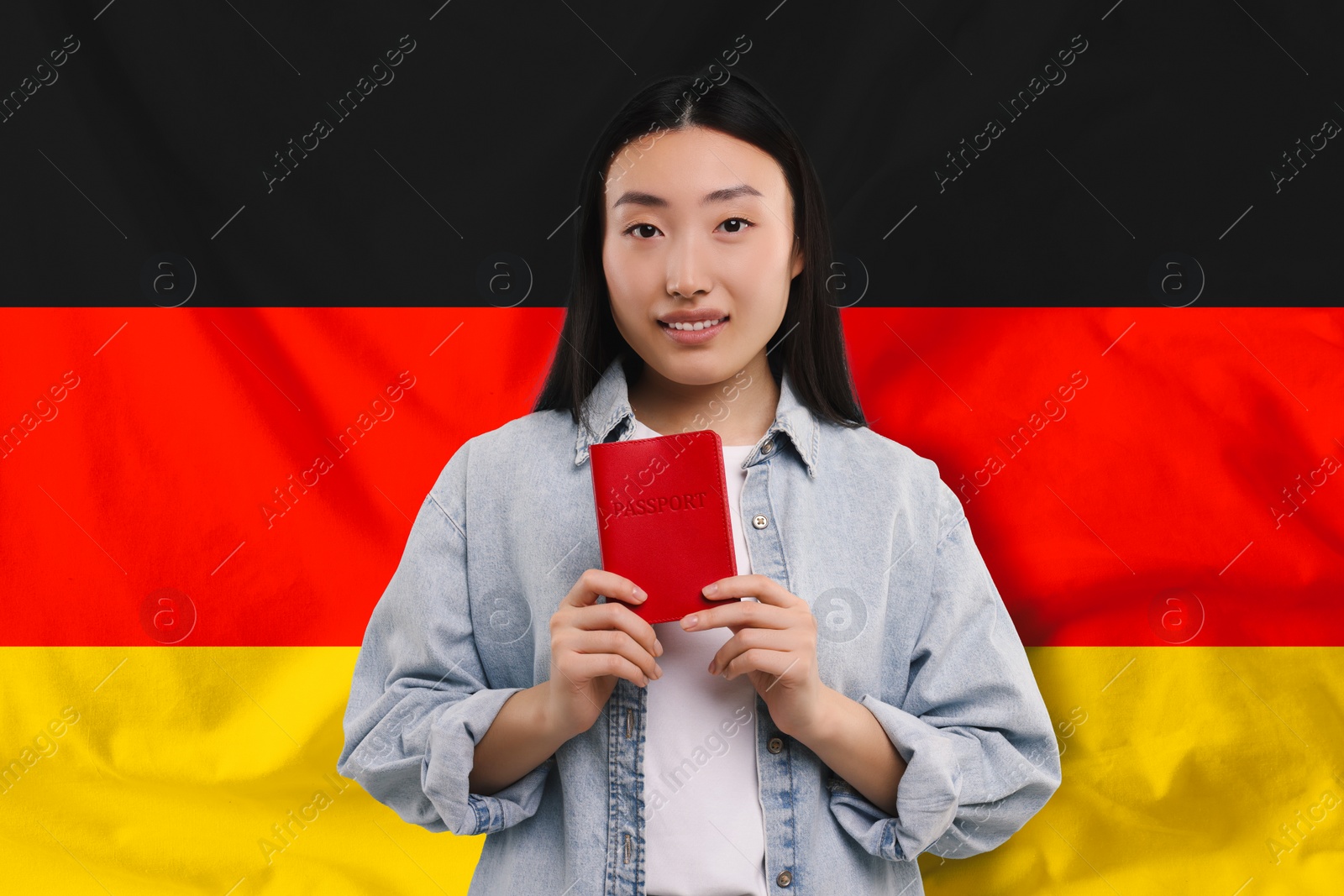 Image of Immigration. Woman with passport against national flag of Germany
