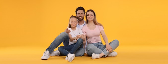 Happy family with child on orange background. Banner design