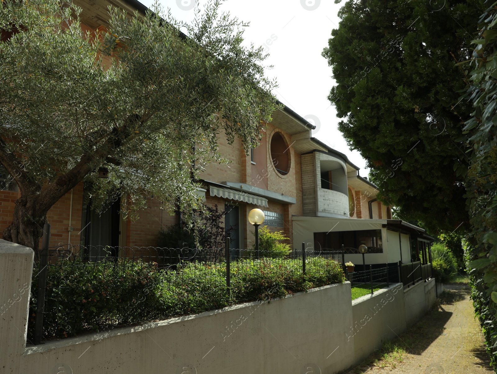 Photo of Street with beautiful residential building and trees on sunny day