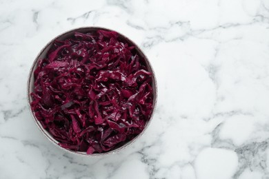 Tasty red cabbage sauerkraut on white marble table, top view. Space for text