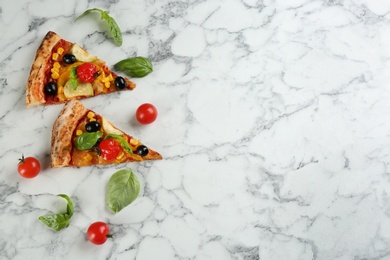 Photo of Delicious vegetable pizza on white marble table, flat lay. Space for text